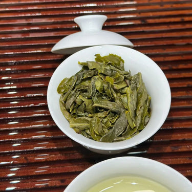 Brewed Tie Guan Yin oolong - bright golden-green liquor in white porcelain gaiwan
